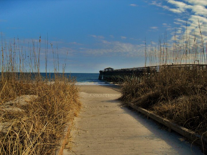 Dune-lined beach access and fishing pier at Myrtle Beach State Park
