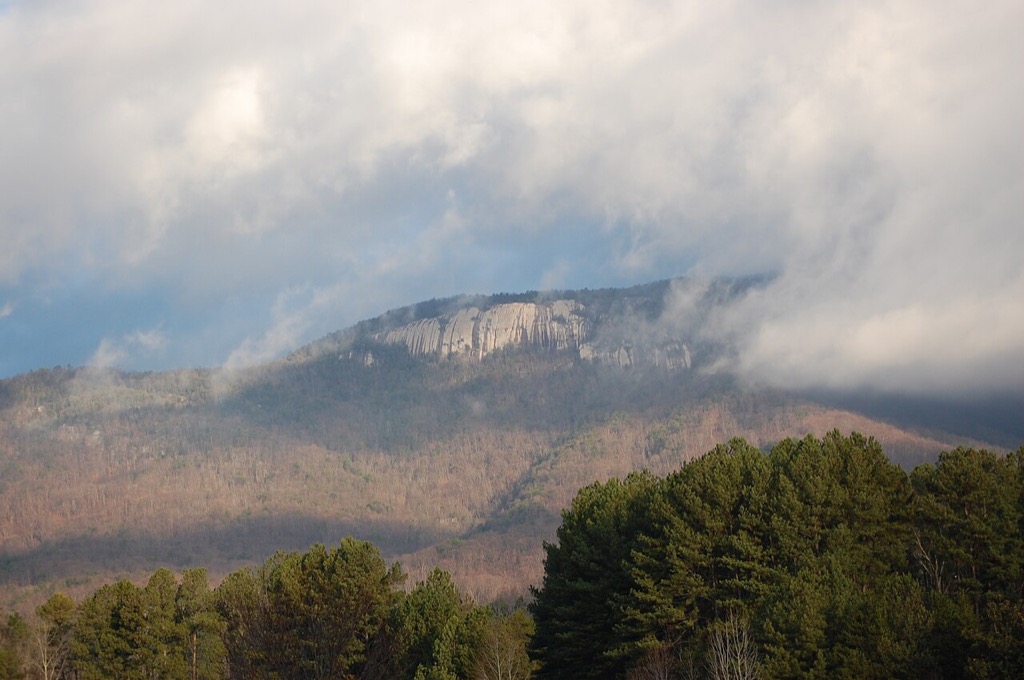 Table Rock Mountain rising above forest beneath low clouds